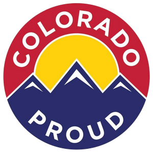 A circular logo with the words Colorado Proud. It features stylized blue mountains with white peaks and a yellow sun against a red background. The text curves around the top and bottom of the circle.