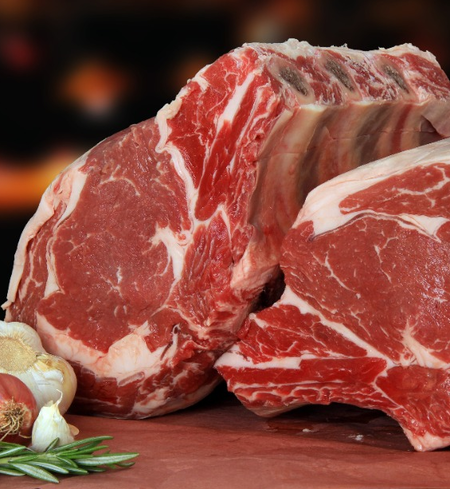 Winterscattleranch Prime Rib Roast - Beef ($35/lb deposit) is shown with marbling, garlic, and rosemary on a dark backdrop—ideal for making a standing rib roast or prime rib roast.