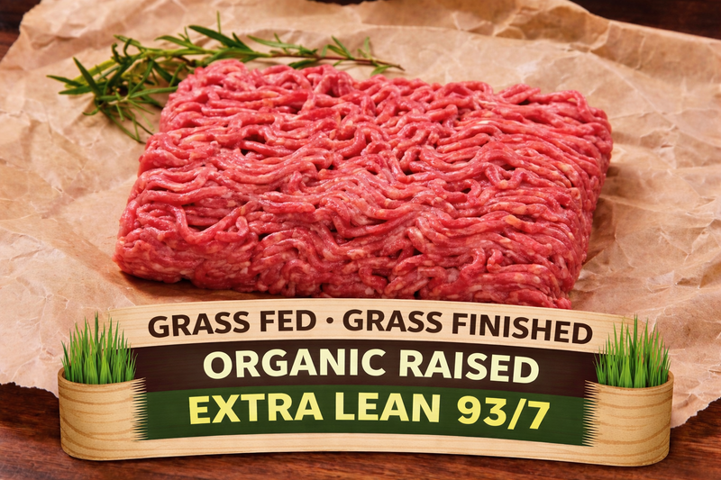 A block of winterscattleranch Organically Pasture Raised Extra Lean Burger Ground Beef Bundle (5–60 lb) rests on parchment paper beside a sprig of rosemary. The label in front highlights its grass-fed, grass-finished, organic upbringing and extra lean 93/7 blend—premium pasture-raised beef raised with no antibiotics.