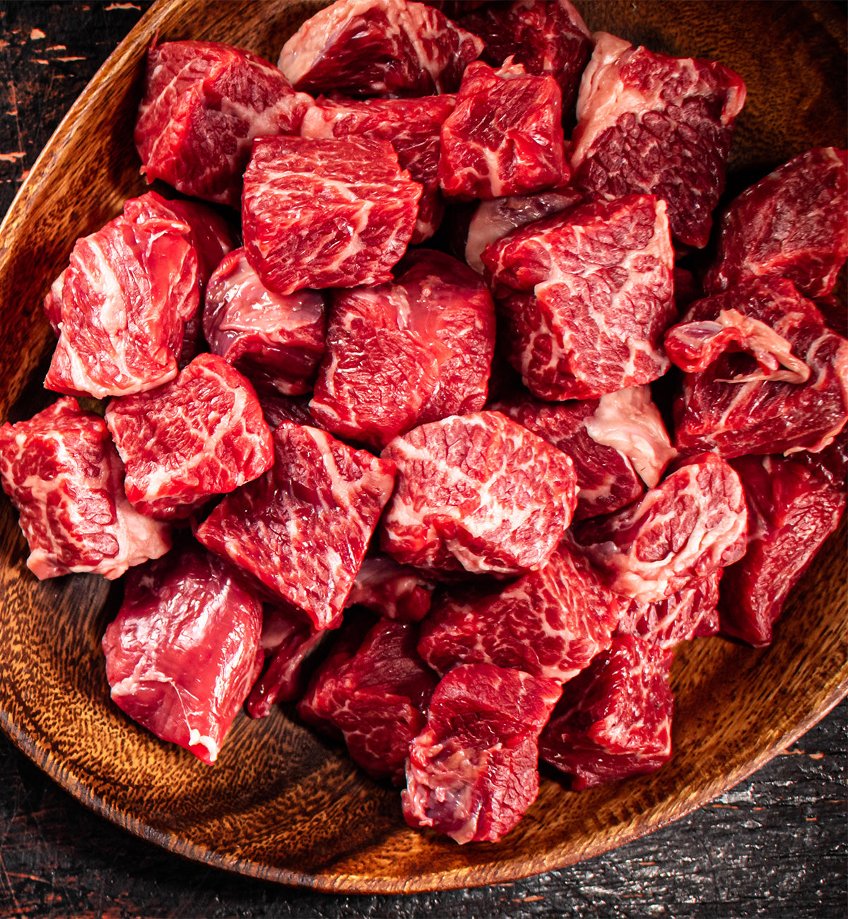 Winters Cattle Ranch Beef Stew Meat—chunks of fresh, marbled grass-fed beef with visible fat streaks, ideal for hearty, nourishing stews.